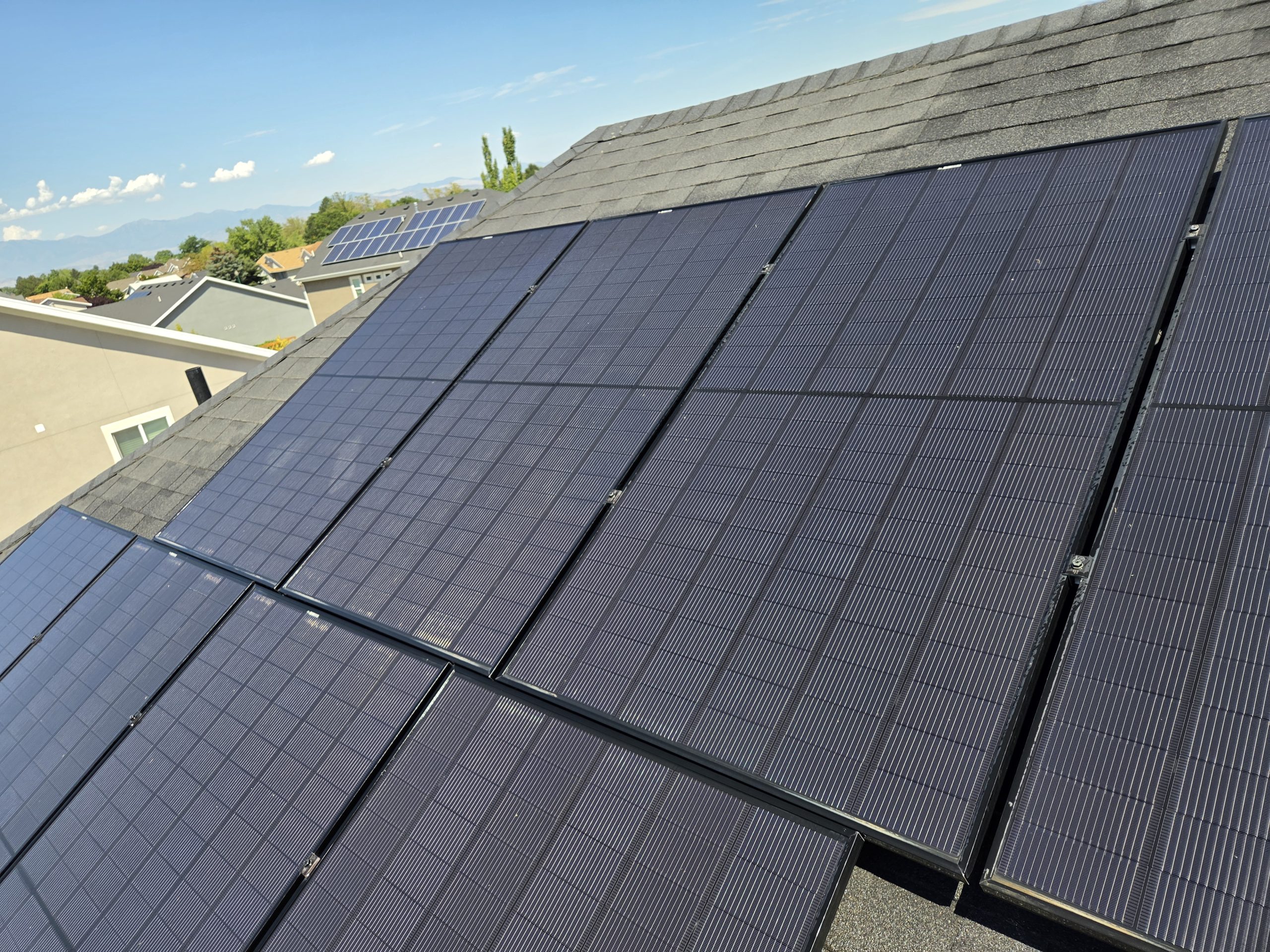 Solar panels on an Orem rooftop with the Wasatch Range in the background