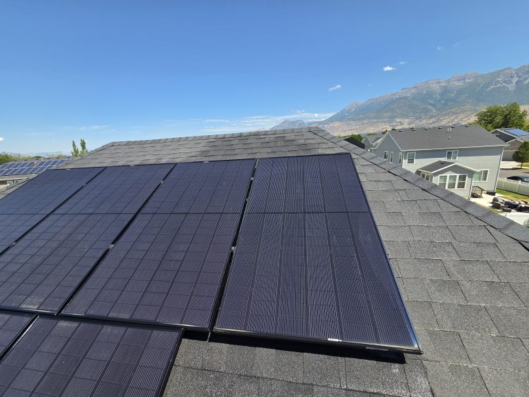 Clean solar panels on an Orem rooftop with the Wasatch Range in the background