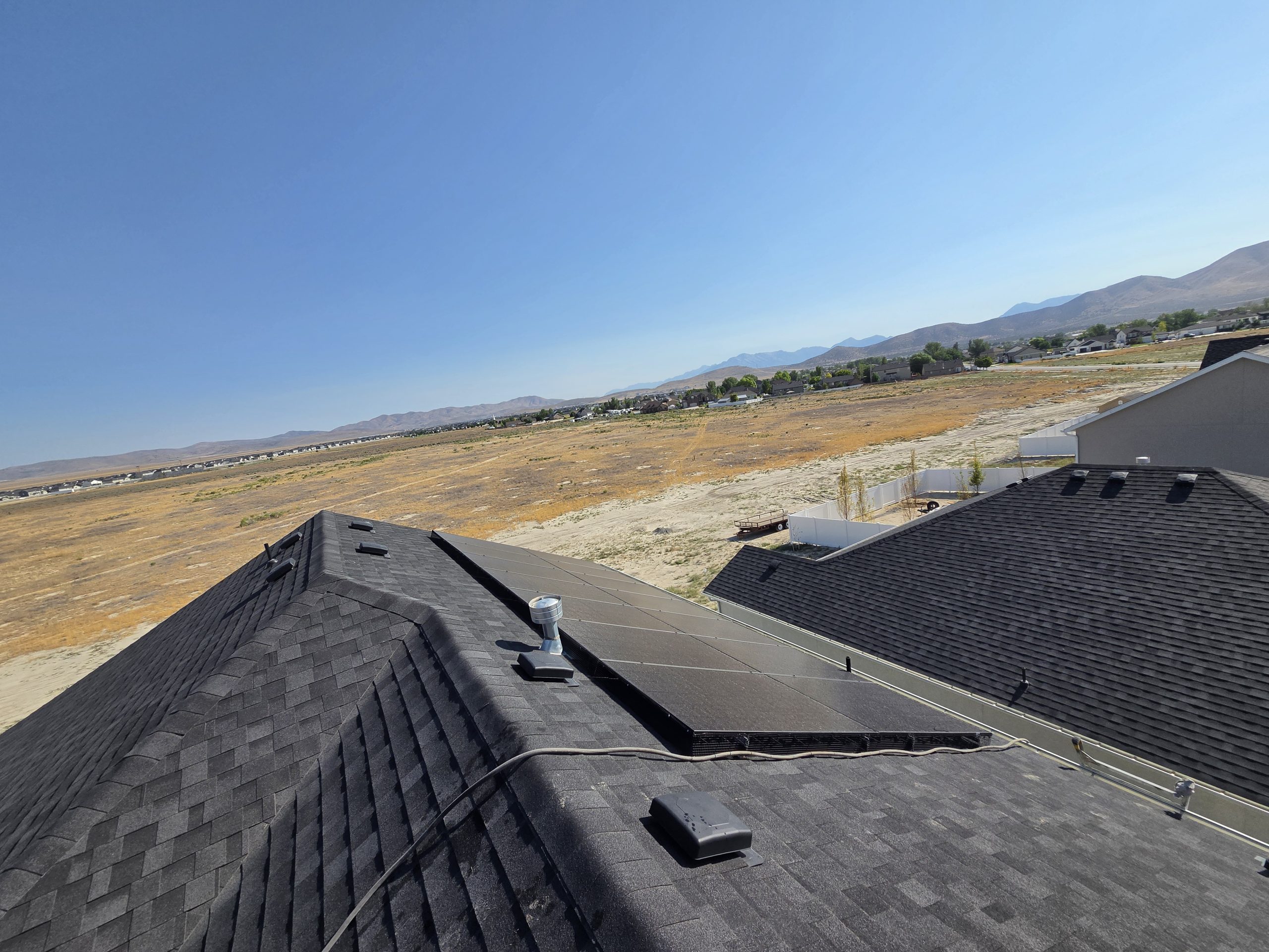 Wide desert view from the rooftop with the panel array in frame