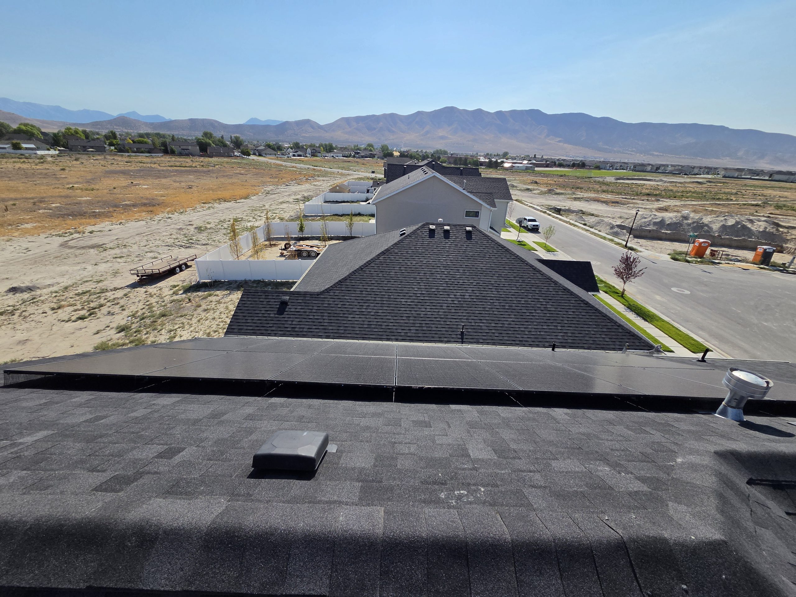 Wide view from the rooftop overlooking the American Fork lot and mountains