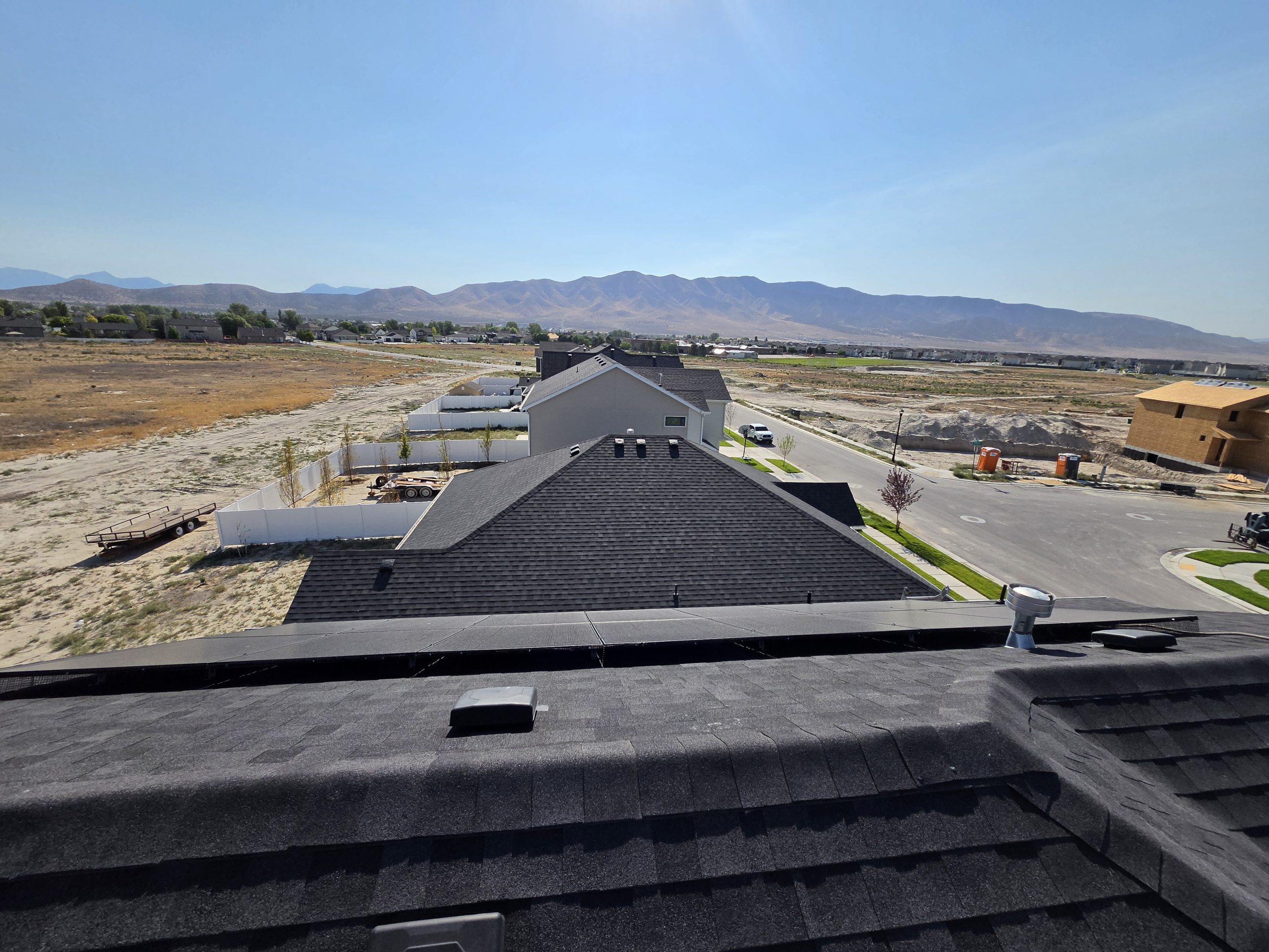 View across the rooftop toward the mountains and surrounding lots