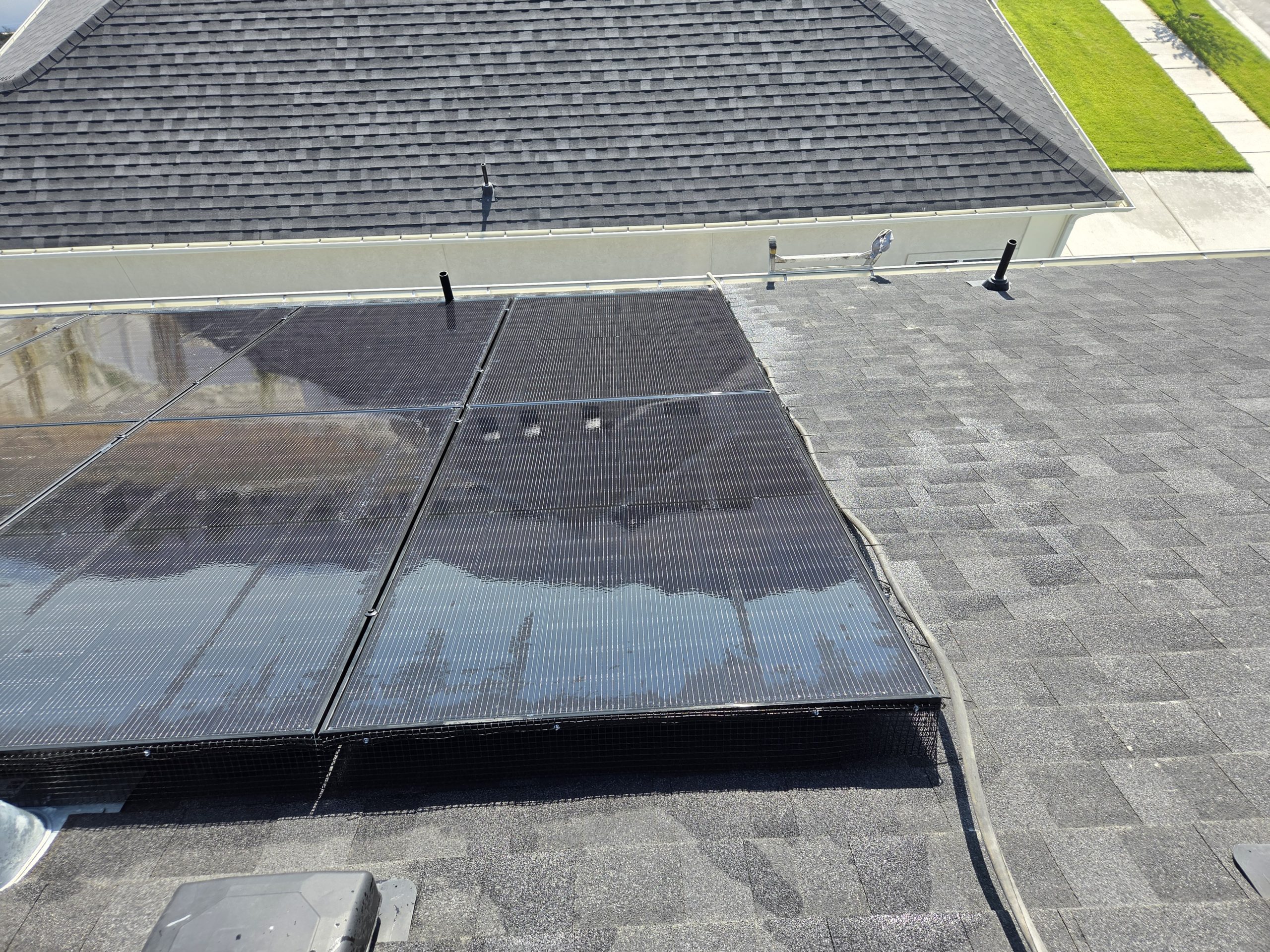 Close-up of a clean solar panel with critter guard netting around the edge