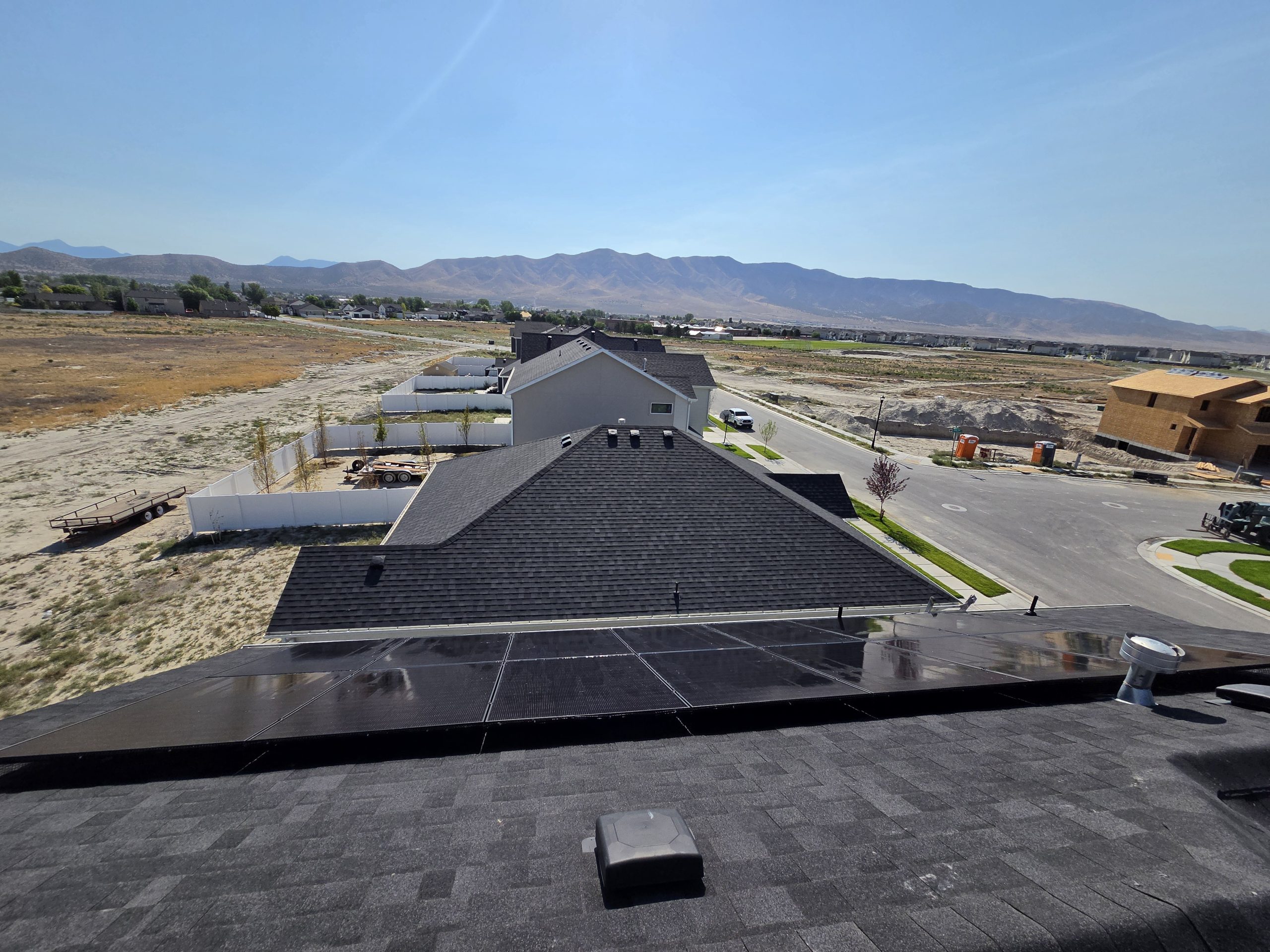 Rooftop view of the new-construction neighborhood and mountains beyond